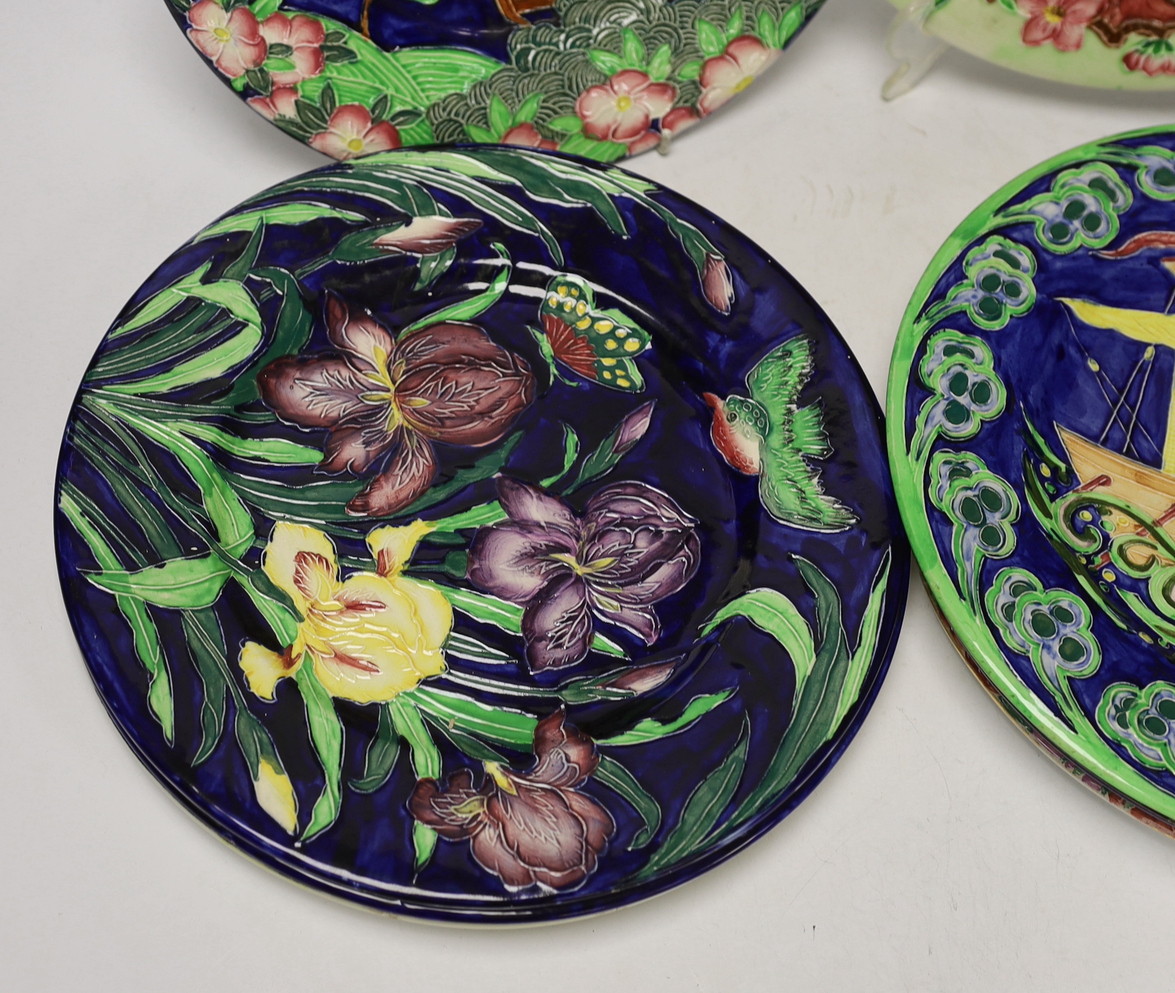 Set of nine Maling, Newcastle pottery plates, many with tube lined decoration including a galleon ship and Windmill, 29cm diameter